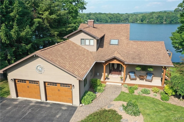 7530 Song Lake Rd, Preble, NY 13159 - view of front of home featuring a shingled roof, covered porch, an attached garage, driveway, and a chimney