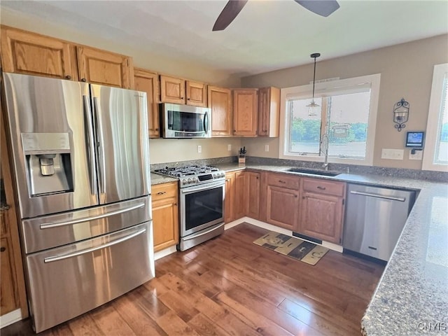 7530 Song Lake Rd, Preble, NY 13159 - kitchen with stainless steel appliances, a ceiling fan, dark wood-type flooring, hanging light fixtures, and light stone countertops