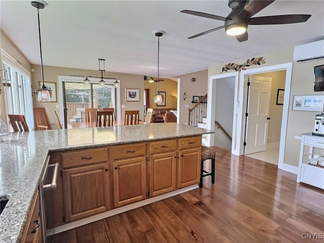 7530 Song Lake Rd, Preble, NY 13159 - kitchen with a wall mounted AC, dark wood-style flooring, a kitchen bar, ceiling fan, and light stone counters