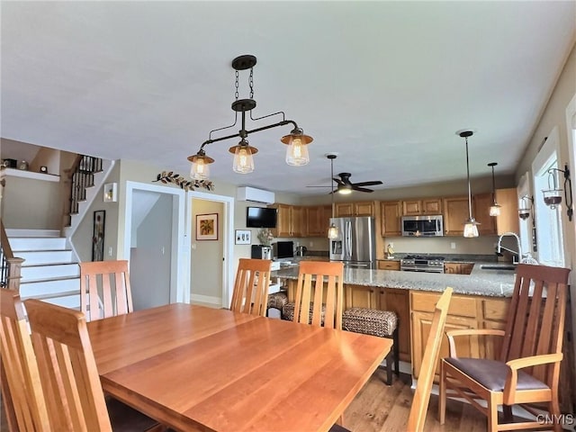7530 Song Lake Rd, Preble, NY 13159 - dining space featuring stairs, a ceiling fan, and light wood-type flooring