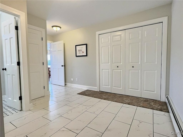 7530 Song Lake Rd, Preble, NY 13159 - unfurnished bedroom with light marble finish floors, a baseboard radiator, and a closet