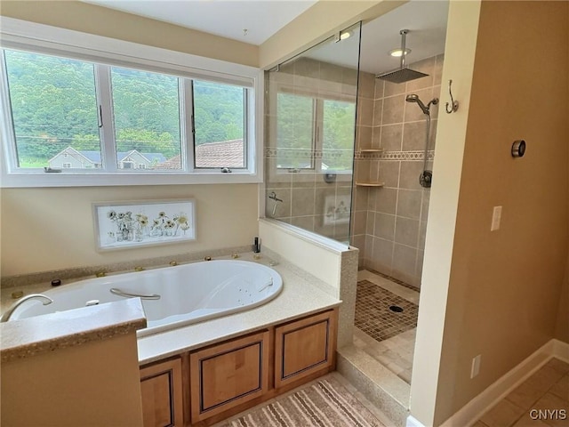7530 Song Lake Rd, Preble, NY 13159 - full bath featuring a jetted tub, a shower stall, healthy amount of natural light, and tile patterned flooring