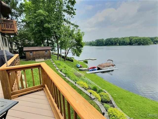 7530 Song Lake Rd, Preble, NY 13159 - wooden deck featuring a water view, a boat dock, a lawn, and a storage shed