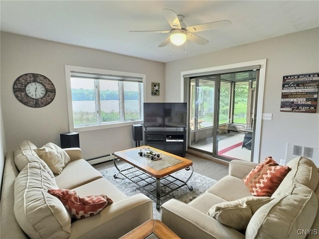 7530 Song Lake Rd, Preble, NY 13159 - living room with healthy amount of natural light, ceiling fan, wood finished floors, and baseboard heating