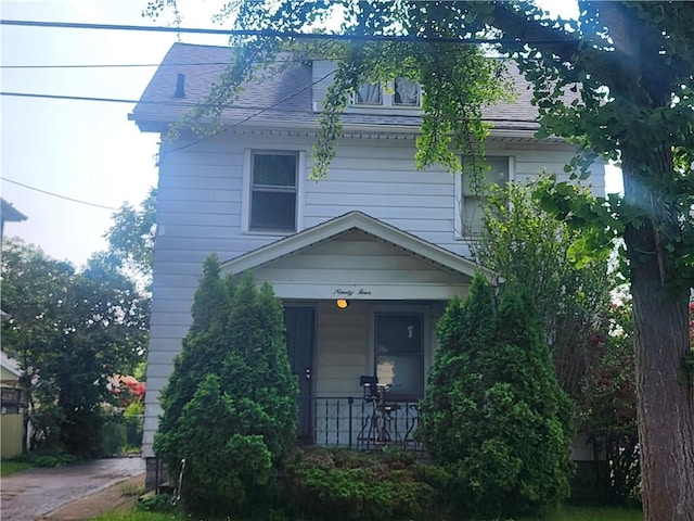 94 Wetmore Park, Rochester, NY 14606 - view of front facade featuring a porch and a shingled roof