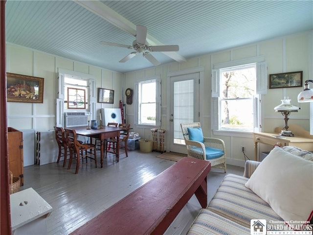 4896 Ashville Bay Rd, North Harmony, NY 14710 - living area featuring cooling unit, wood finished floors, a decorative wall, a ceiling fan, and healthy amount of natural light