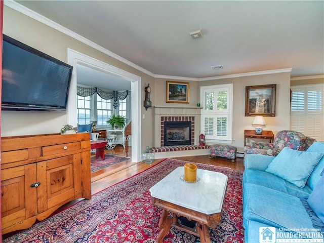 4896 Ashville Bay Rd, North Harmony, NY 14710 - living area with ornamental molding, plenty of natural light, wood finished floors, a brick fireplace, and a baseboard radiator