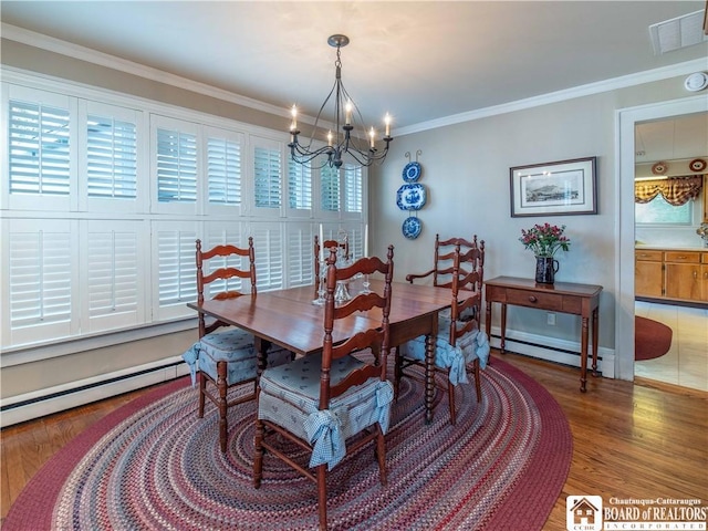 4896 Ashville Bay Rd, North Harmony, NY 14710 - dining area featuring a baseboard radiator, a chandelier, wood finished floors, and crown molding