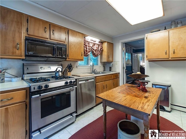 4896 Ashville Bay Rd, North Harmony, NY 14710 - kitchen featuring stainless steel appliances, light countertops, and brown cabinetry