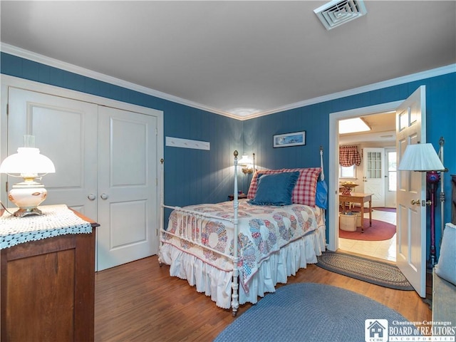 4896 Ashville Bay Rd, North Harmony, NY 14710 - bedroom with crown molding, wood finished floors, and a closet