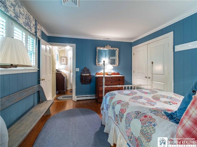 4896 Ashville Bay Rd, North Harmony, NY 14710 - bedroom featuring wood finished floors, ornamental molding, a closet, and baseboard heating