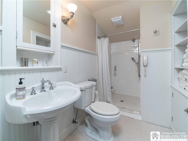 4896 Ashville Bay Rd, North Harmony, NY 14710 - bathroom with a wainscoted wall, a stall shower, and tile patterned flooring