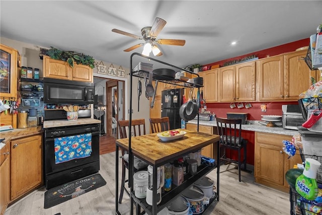 172 E 2nd St, Corning-City, NY 14830 - kitchen featuring black appliances, light countertops, a ceiling fan, and light wood-type flooring