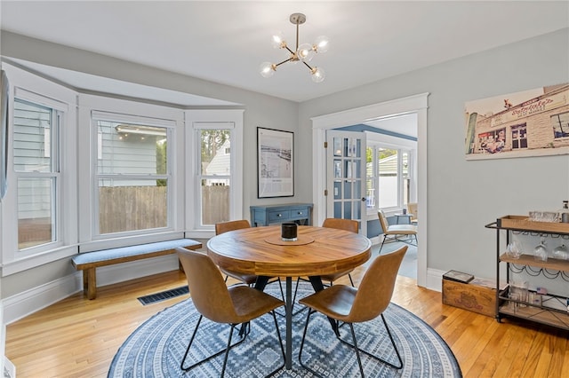 45 Croydon Rd, Rochester, NY 14610 - dining room with a chandelier, light wood-type flooring, and french doors