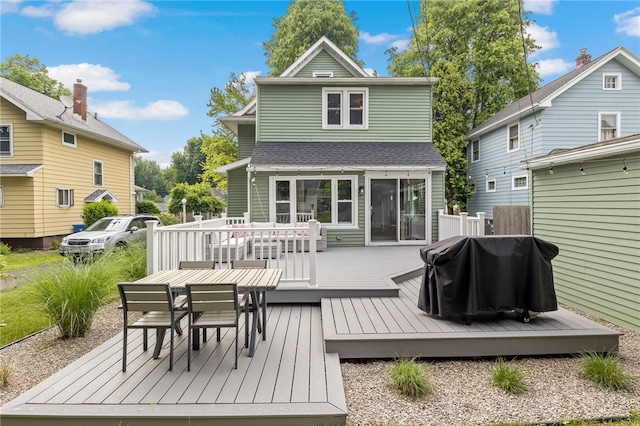 45 Croydon Rd, Rochester, NY 14610 - rear view of house featuring a wooden deck, outdoor dining area, and roof with shingles