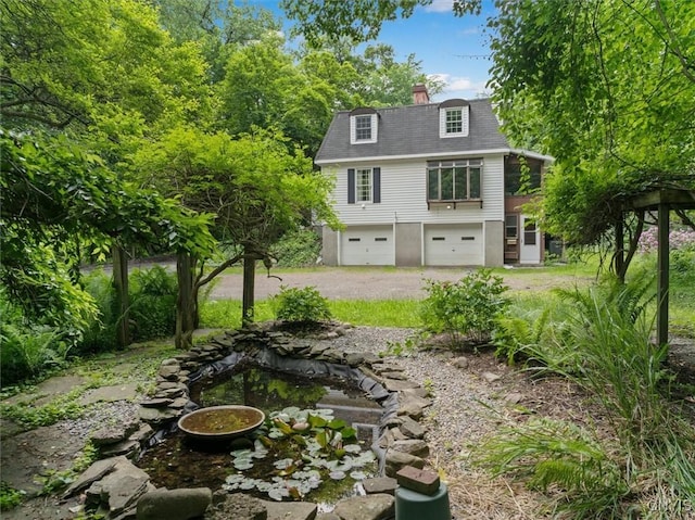 13 Dodd St, Whitestown, NY 13492 - rear view of house featuring driveway, a garage, and a chimney