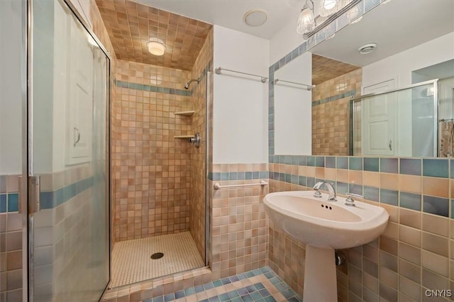 13 Dodd St, Whitestown, NY 13492 - bathroom with tile walls, a shower stall, and tile patterned flooring