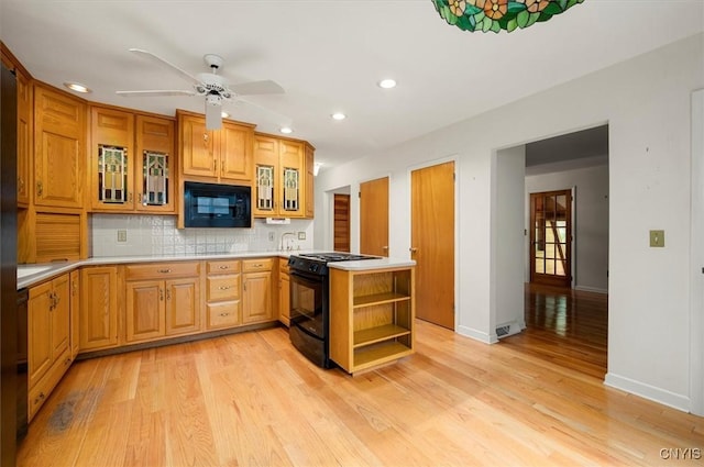 13 Dodd St, Whitestown, NY 13492 - kitchen with black appliances, open shelves, recessed lighting, light wood-style flooring, and decorative backsplash