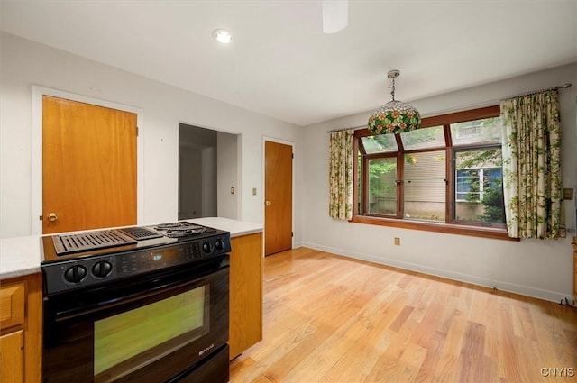 13 Dodd St, Whitestown, NY 13492 - kitchen with black stove, light countertops, light wood finished floors, and brown cabinetry