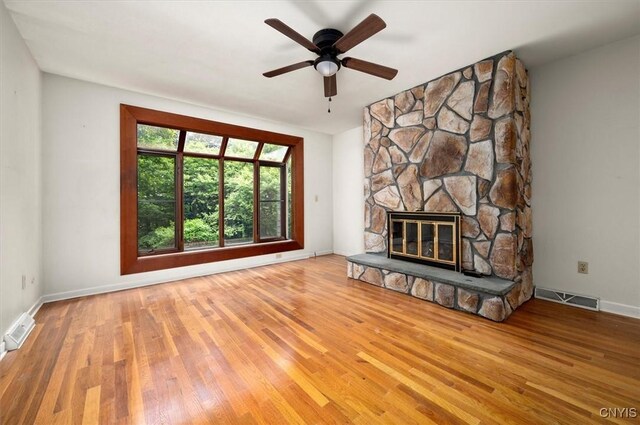 13 Dodd St, Whitestown, NY 13492 - unfurnished living room featuring wood finished floors, a fireplace, and a ceiling fan