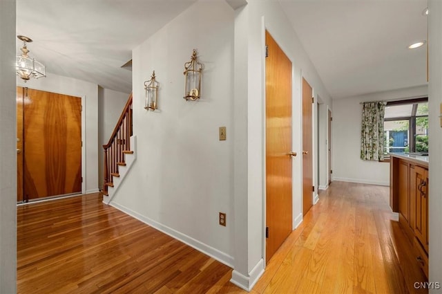 13 Dodd St, Whitestown, NY 13492 - corridor featuring light wood finished floors, stairway, recessed lighting, and a chandelier