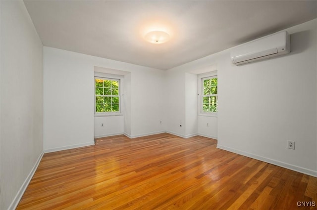 13 Dodd St, Whitestown, NY 13492 - empty room featuring a wall mounted air conditioner and light wood finished floors