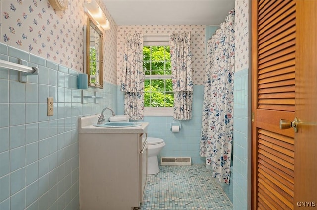 13 Dodd St, Whitestown, NY 13492 - bathroom featuring tile walls, wallpapered walls, vanity, tile patterned flooring, and wainscoting