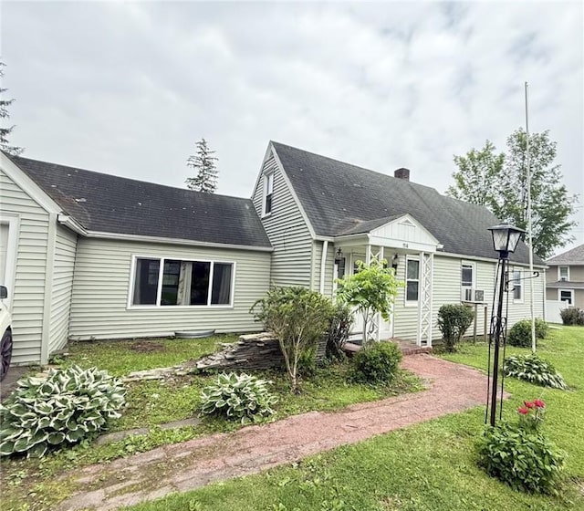 114 W Main St, Sidney, NY 13838 - back of property featuring a yard, a chimney, and a shingled roof