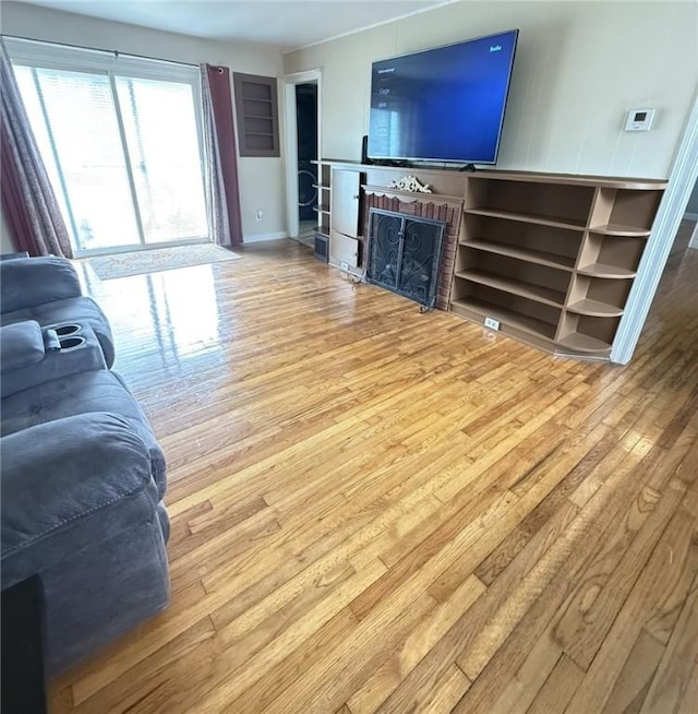 114 W Main St, Sidney, NY 13838 - living area with hardwood / wood-style floors and a fireplace