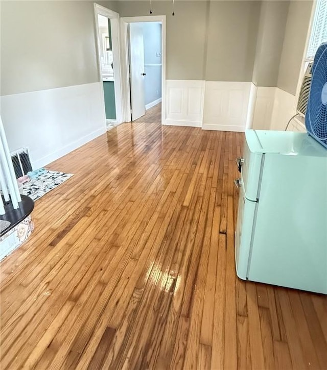 114 W Main St, Sidney, NY 13838 - unfurnished room with wood-type flooring, a wainscoted wall, and washer / clothes dryer