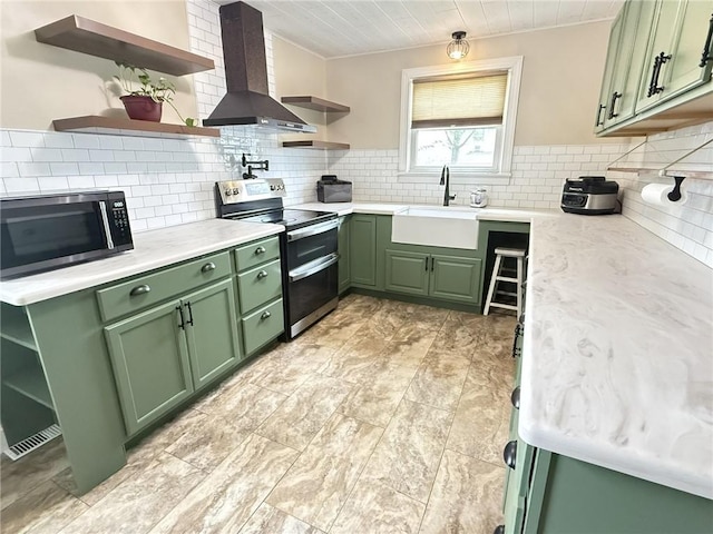 114 W Main St, Sidney, NY 13838 - kitchen with green cabinets, open shelves, appliances with stainless steel finishes, wall chimney exhaust hood, and backsplash
