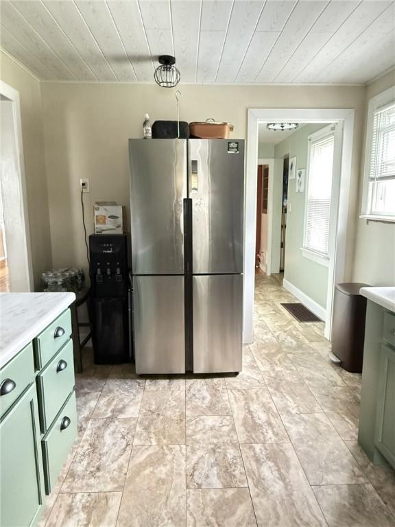 114 W Main St, Sidney, NY 13838 - kitchen with freestanding refrigerator, green cabinetry, light countertops, and wooden ceiling