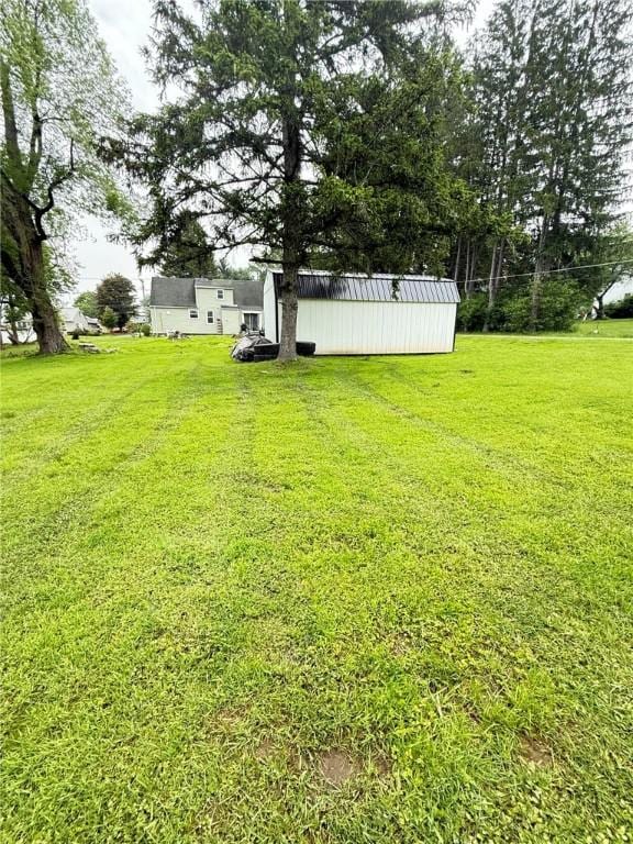 114 W Main St, Sidney, NY 13838 - view of green lawn featuring an outdoor structure