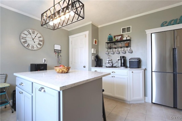 19536 State Route 3, Hounsfield, NY 13601 - kitchen with stainless steel fridge, ornamental molding, white cabinets, a kitchen island, and light stone counters