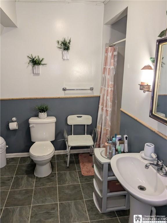 650 Barrows St, Jamestown, NY 14701 - full bathroom with toilet and a shower with shower curtain