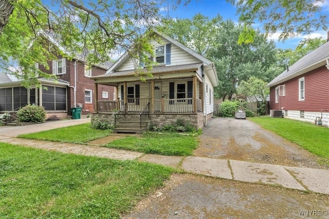 709 87th St, Niagara Falls, NY 14304 - bungalow-style house featuring a porch, a sunroom, and a front yard
