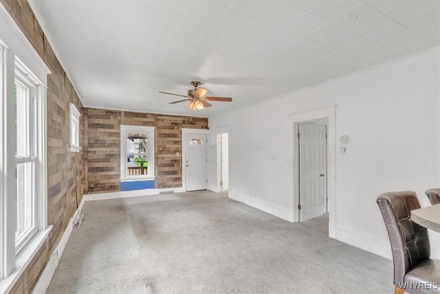 709 87th St, Niagara Falls, NY 14304 - unfurnished living room with ceiling fan and wood walls