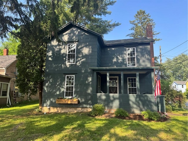 201 Sheppard St, Milo, NY 14527 - view of front facade with a front lawn, a chimney, and a porch