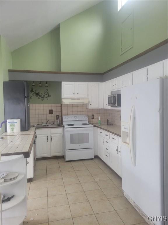 3903 Lafayette Rd, Lafayette, NY 13078 - kitchen featuring white appliances, tile countertops, white cabinetry, decorative backsplash, and light tile patterned flooring