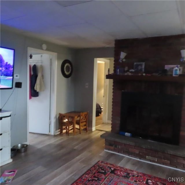 3903 Lafayette Rd, Lafayette, NY 13078 - living area featuring a brick fireplace and wood finished floors
