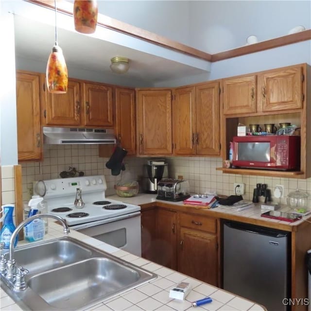 3903 Lafayette Rd, Lafayette, NY 13078 - kitchen with under cabinet range hood, white electric range oven, tile counters, refrigerator, and tasteful backsplash
