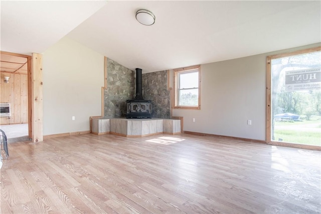 46946 Dingman Point Rd, Alexandria, NY 13607 - unfurnished living room with light wood-style floors and a wood stove