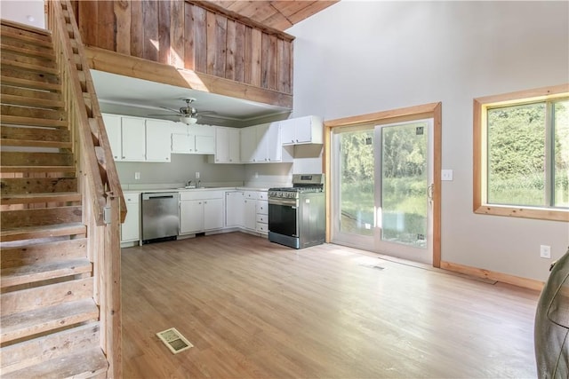 46946 Dingman Point Rd, Alexandria, NY 13607 - kitchen featuring appliances with stainless steel finishes, healthy amount of natural light, light wood-style flooring, high vaulted ceiling, and light countertops