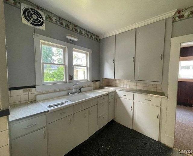 551/2 N Helmer Ave, Manheim, NY 13329 - kitchen with light countertops, decorative backsplash, and white cabinetry