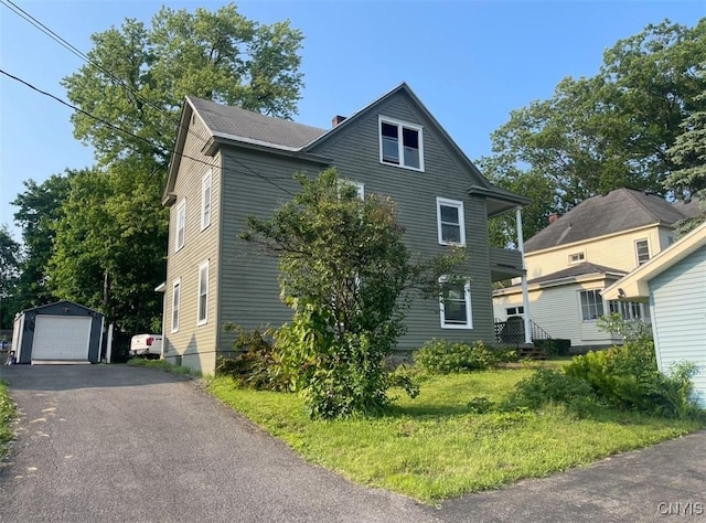 551/2 N Helmer Ave, Manheim, NY 13329 - view of front of property featuring a detached garage, an outdoor structure, asphalt driveway, and a chimney