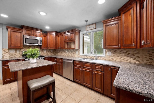 7698 Anchor Dr, Clay, NY 13090 - kitchen featuring stainless steel appliances, light tile patterned flooring, pendant lighting, a center island, and recessed lighting
