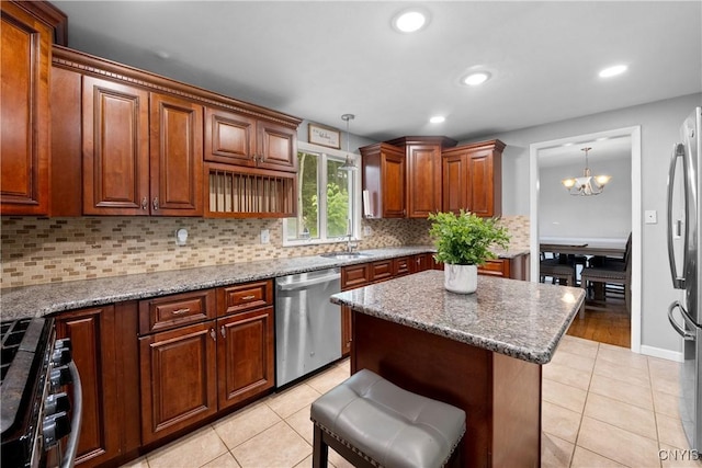 7698 Anchor Dr, Clay, NY 13090 - kitchen featuring stainless steel appliances, light tile patterned flooring, a chandelier, tasteful backsplash, and hanging light fixtures