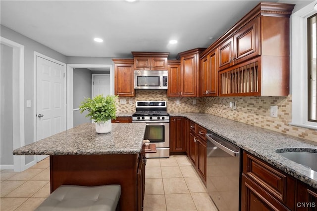 7698 Anchor Dr, Clay, NY 13090 - kitchen with stainless steel appliances, light tile patterned floors, light stone counters, tasteful backsplash, and recessed lighting