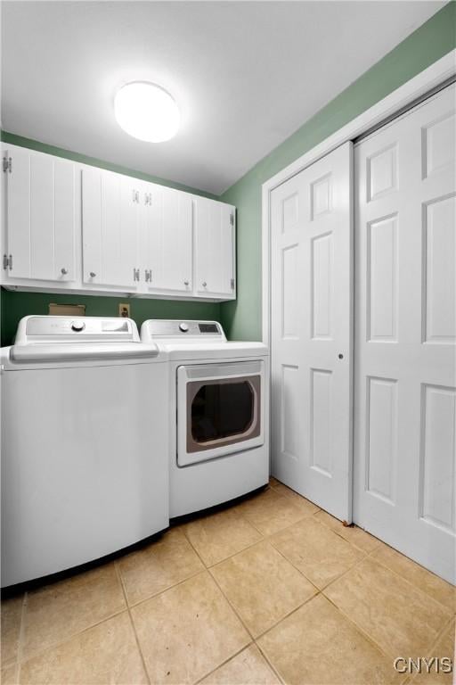 7698 Anchor Dr, Clay, NY 13090 - laundry area featuring cabinet space, separate washer and dryer, and light tile patterned flooring