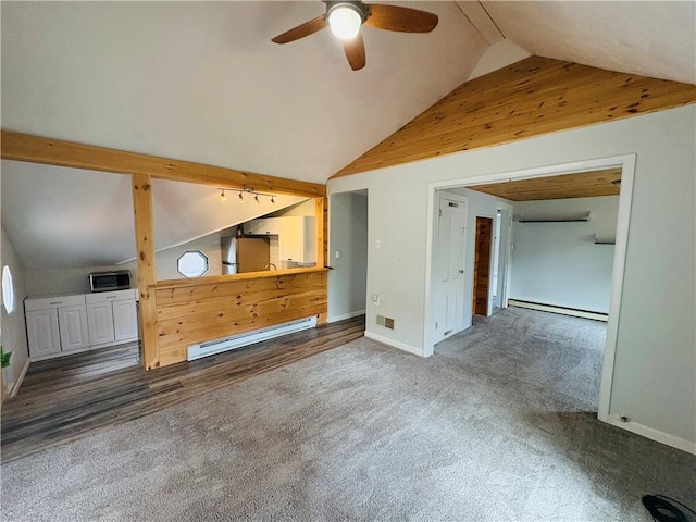 216 W William St Unit 201, Corning-City, NY 14830 - unfurnished living room featuring a baseboard radiator, carpet floors, ceiling fan, wooden walls, and high vaulted ceiling